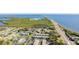 Aerial view of the neighborhood showcasing the bay, community, greenery, and a scenic road at 345 S Mcmullen Booth Rd # 142, Clearwater, FL 33759
