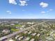 Wide aerial view of condos near a highway with sprawling greenery and the city beyond at 345 S Mcmullen Booth Rd # 142, Clearwater, FL 33759