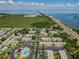 Aerial image displaying waterfront condominiums, lush landscapes, and highway access at 345 S Mcmullen Booth Rd # 142, Clearwater, FL 33759
