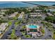Overhead view featuring condominium community with swimming pool, parking, and tropical landscaping at 345 S Mcmullen Booth Rd # 142, Clearwater, FL 33759