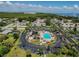 The aerial view displays the community pool nestled within a residential area near the picturesque waterfront at 345 S Mcmullen Booth Rd # 142, Clearwater, FL 33759
