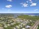 Aerial view of condos with mature trees, highway, and lake in the distance at 345 S Mcmullen Booth Rd # 142, Clearwater, FL 33759