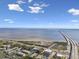 Aerial view of condos with mature trees, water views, and a bridge in the distance at 345 S Mcmullen Booth Rd # 142, Clearwater, FL 33759