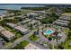 Bird's eye view of condominium complex featuring pool, parking, and manicured grounds by the water at 345 S Mcmullen Booth Rd # 142, Clearwater, FL 33759