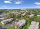 Aerial view of condos with mature trees and convenient parking near a major highway at 345 S Mcmullen Booth Rd # 142, Clearwater, FL 33759