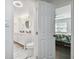 A view of the bathroom with modern fixtures and finishes and a bedroom in the background at 345 S Mcmullen Booth Rd # 142, Clearwater, FL 33759