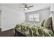 Bedroom with tropical themed bedding and dark hardwood floors at 345 S Mcmullen Booth Rd # 142, Clearwater, FL 33759