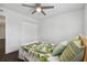 Bright bedroom features dark wood floor, ceiling fan, and closet with bi-fold doors at 345 S Mcmullen Booth Rd # 142, Clearwater, FL 33759