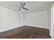 A bright bedroom with dark hardwood floors and a ceiling fan provides a relaxing atmosphere at 345 S Mcmullen Booth Rd # 142, Clearwater, FL 33759