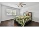 Bedroom with tropical themed bedding and dark hardwood floors at 345 S Mcmullen Booth Rd # 142, Clearwater, FL 33759