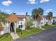 Well-maintained condo featuring tropical landscaping, a brown roof, and multiple entrances at 345 S Mcmullen Booth Rd # 142, Clearwater, FL 33759