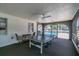 Community game room features a ping pong table, ceiling fan, and an open view of the community pool and tiki hut at 345 S Mcmullen Booth Rd # 142, Clearwater, FL 33759