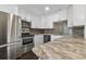 Modern kitchen with stainless appliances, mosaic backsplash, and island counter at 345 S Mcmullen Booth Rd # 142, Clearwater, FL 33759