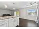Open concept kitchen flows into the living room with patio access at 345 S Mcmullen Booth Rd # 142, Clearwater, FL 33759