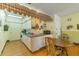 Cozy kitchen featuring white cabinetry, a unique mural, and a charming breakfast nook at 345 S Mcmullen Booth Rd # 142, Clearwater, FL 33759