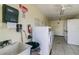 Clean laundry room with multiple washers and dryers, sink, tile floor, and bright lighting at 345 S Mcmullen Booth Rd # 142, Clearwater, FL 33759