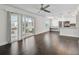 Open-concept living space with sliding glass doors, hardwood floors, and modern kitchen at 345 S Mcmullen Booth Rd # 142, Clearwater, FL 33759
