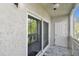 Screened patio with sliding doors and white door at 345 S Mcmullen Booth Rd # 142, Clearwater, FL 33759