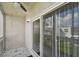 Screened patio with sliding doors and ceiling fan at 345 S Mcmullen Booth Rd # 142, Clearwater, FL 33759