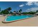 Outdoor pool area surrounded by palm trees and tiki umbrellas, perfect for relaxation at 345 S Mcmullen Booth Rd # 142, Clearwater, FL 33759
