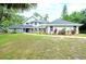 Beautiful two-story home with mature landscaping and a welcoming walkway leading to the front door at 35 Deerpath Dr, Oldsmar, FL 34677