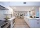 Open-concept kitchen with island, stainless appliances, flows into the living room with fireplace and wood beam accents at 35 Deerpath Dr, Oldsmar, FL 34677
