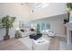 Bright living room with high ceilings, fireplace, and sliding doors that lead to a pool at 35 Deerpath Dr, Oldsmar, FL 34677
