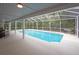 Screened in pool area featuring an inground pool and outdoor seating at 35 Deerpath Dr, Oldsmar, FL 34677