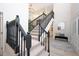 Elegant staircase with dark wood railings, leading to the upper level, with views of the entry and light wood floors at 35 Deerpath Dr, Oldsmar, FL 34677