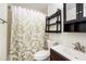 Bathroom with shower, toilet, sink, and a leaf-patterned shower curtain at 4014 Dream Oak Pl # 202, Tampa, FL 33613