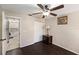 Comfortable bedroom featuring dark wood floors, a ceiling fan, and natural light at 4014 Dream Oak Pl # 202, Tampa, FL 33613