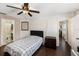 Inviting bedroom with ceiling fan, wood floors, and ensuite bathroom at 4014 Dream Oak Pl # 202, Tampa, FL 33613