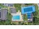 Aerial photo showing a pool, a tennis court, and clubhouse amenities for community residents at 4014 Dream Oak Pl # 202, Tampa, FL 33613