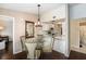 Dining room area with a chandelier and a view of the kitchen and living areas, perfect for entertaining at 4014 Dream Oak Pl # 202, Tampa, FL 33613