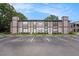 Three-story exterior elevation of a multi-Gathering dwelling with lush landscaping and on-site parking at 4014 Dream Oak Pl # 202, Tampa, FL 33613