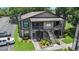Two-story exterior elevation of a multi-Gathering dwelling with lush landscaping and on-site parking at 4014 Dream Oak Pl # 202, Tampa, FL 33613