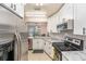Modern kitchen featuring stainless steel refrigerator and stove, and white cabinets at 4014 Dream Oak Pl # 202, Tampa, FL 33613