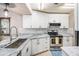 Gorgeous kitchen featuring white cabinets, stainless steel appliances, and granite countertops at 4014 Dream Oak Pl # 202, Tampa, FL 33613