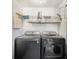 A laundry room with updated washer and dryer, and built in shelves at 4014 Dream Oak Pl # 202, Tampa, FL 33613
