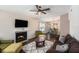 Inviting living room with a fireplace, ceiling fan, and a view into the dining area at 4014 Dream Oak Pl # 202, Tampa, FL 33613