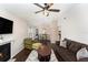 Open concept living room featuring a fireplace, ceiling fan, and seamless transition to the dining area at 4014 Dream Oak Pl # 202, Tampa, FL 33613