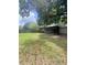Spacious backyard features mature trees, a screened porch, and a privacy fence at 4639 Cabbage Palm Dr, Valrico, FL 33596