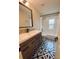 Bathroom with a modern vanity and decorative tiled floor at 4639 Cabbage Palm Dr, Valrico, FL 33596