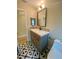 Updated bathroom features patterned tile flooring and a modern vanity with a black faucet and square mirror at 4639 Cabbage Palm Dr, Valrico, FL 33596