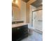 Bathroom featuring a modern vanity, an arch mirror, and a glass-enclosed shower at 4639 Cabbage Palm Dr, Valrico, FL 33596
