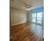 Bright bedroom features wood floors, a ceiling fan and large window with natural light at 4639 Cabbage Palm Dr, Valrico, FL 33596