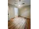 Bedroom boasts wood-look floors, a ceiling fan, and an open closet for ample storage at 4639 Cabbage Palm Dr, Valrico, FL 33596