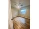 This bedroom has wood-look flooring, a ceiling fan, and a window with natural light at 4639 Cabbage Palm Dr, Valrico, FL 33596