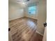 Bedroom with wood floors, ceiling fan and a window that offers natural light at 4639 Cabbage Palm Dr, Valrico, FL 33596