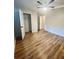 Bedroom with wood floors, a ceiling fan and access to a walk-in closet at 4639 Cabbage Palm Dr, Valrico, FL 33596